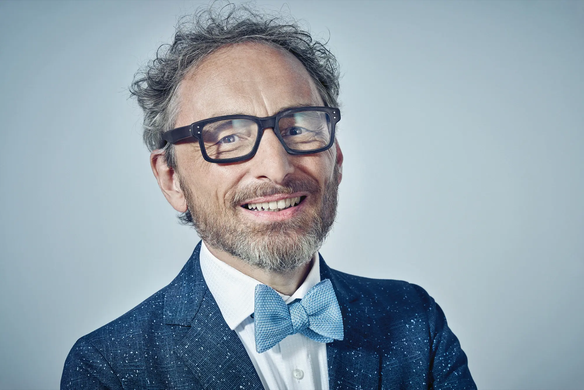 Christoph Holz smiling in blue bow tie